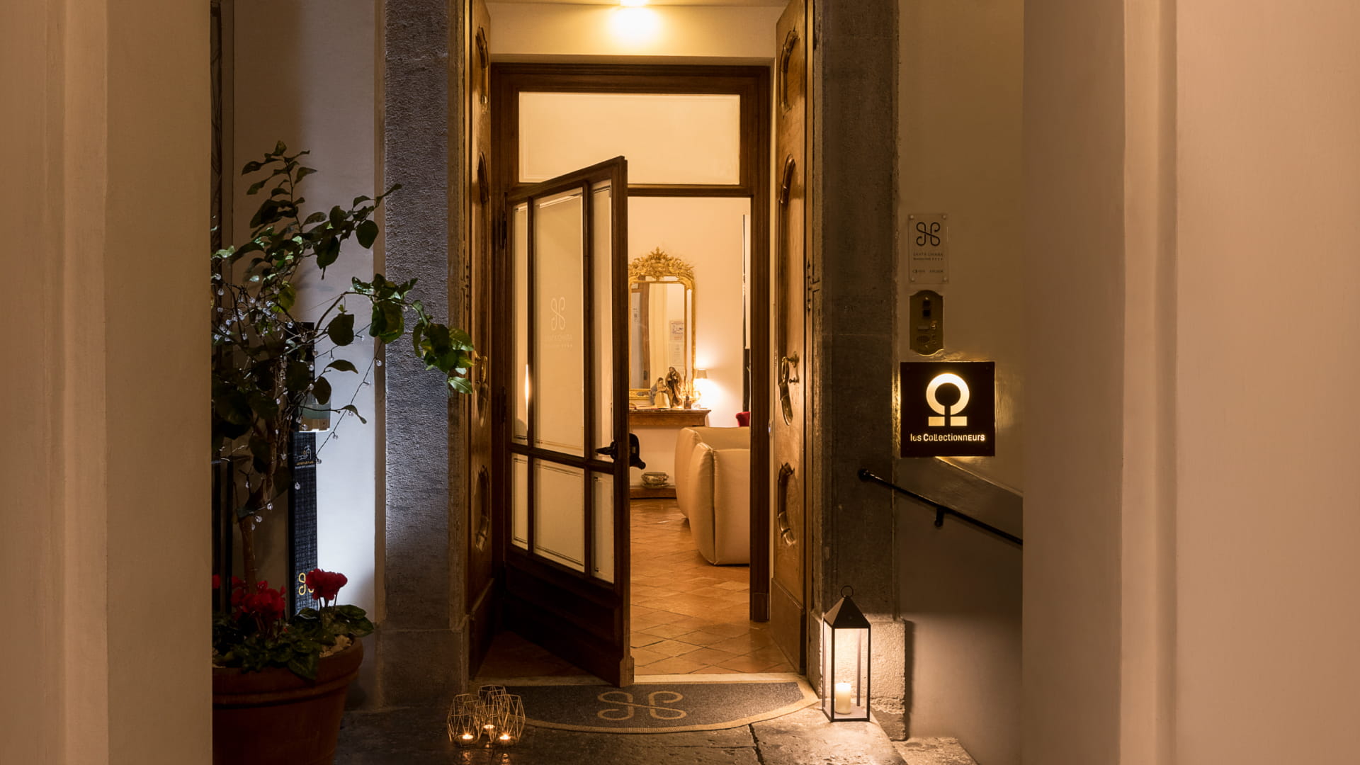 Entrance of Santa Chiara Boutique Hotel at night.