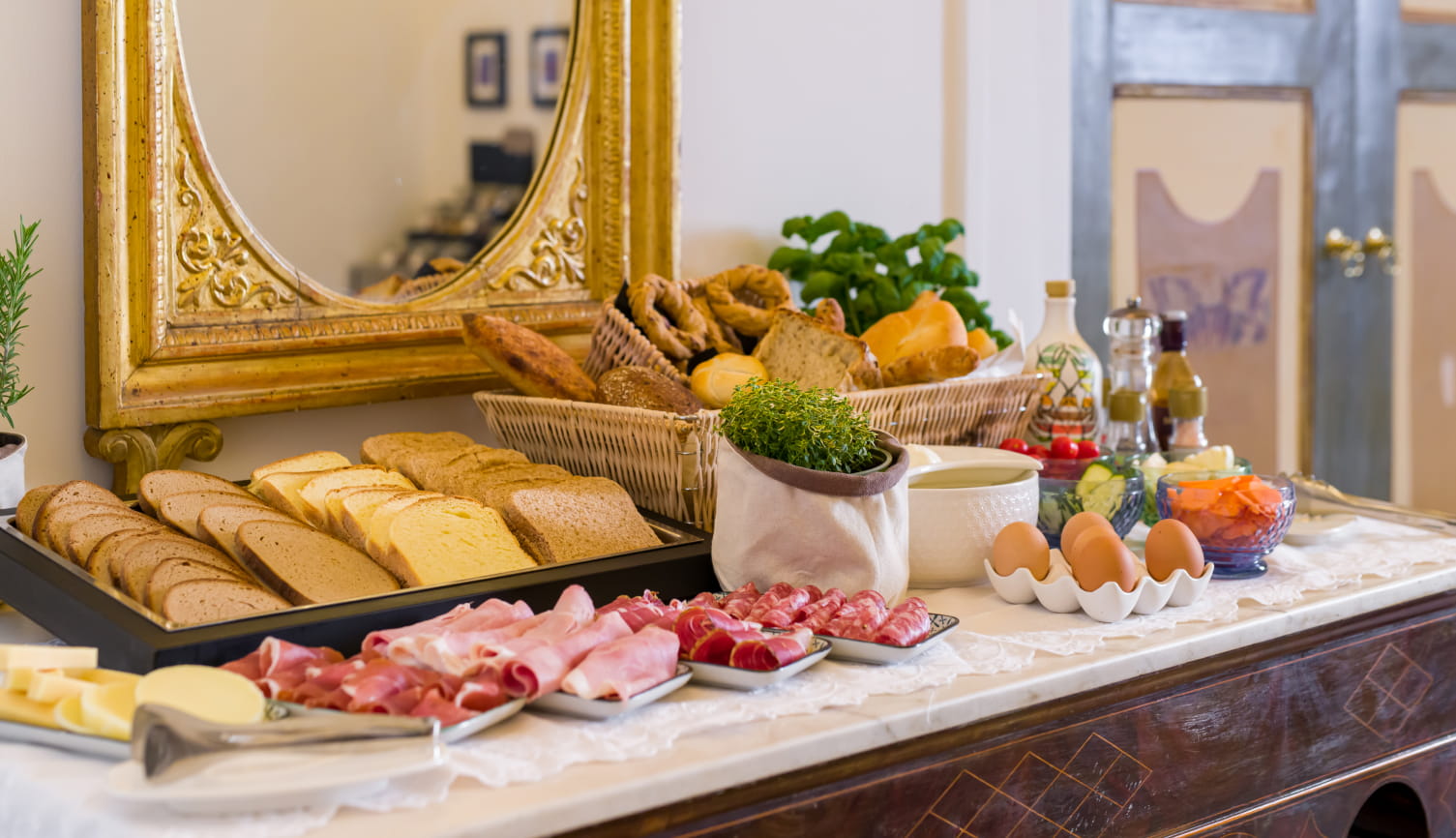Selection of savory breakfast products at Santa Chiara Boutique Hotel.
