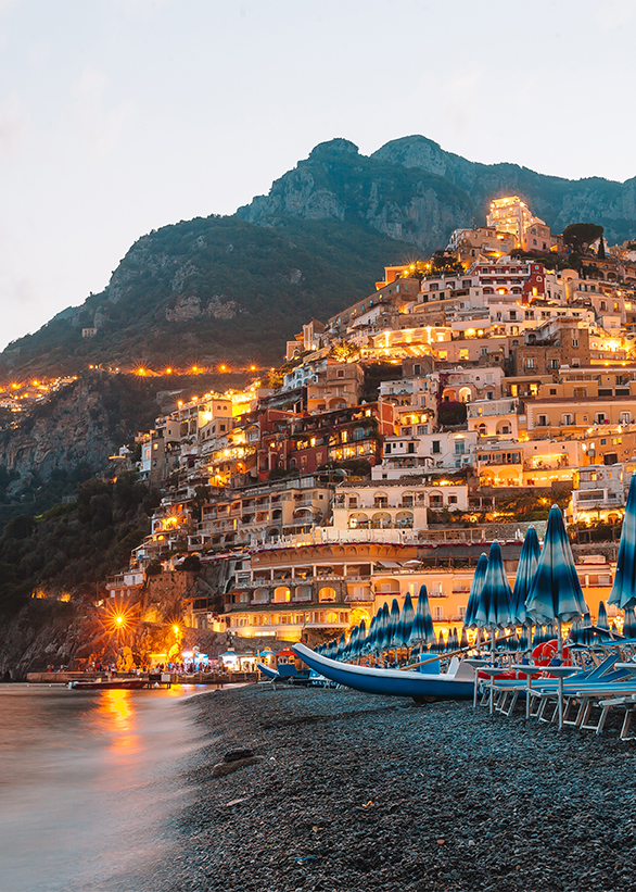Beautiful coastal towns of Italy – scenic Positano in Amalfi coast Night Positano on the Amalfi Coast in Italy. View from the famous beach to the village in the lights