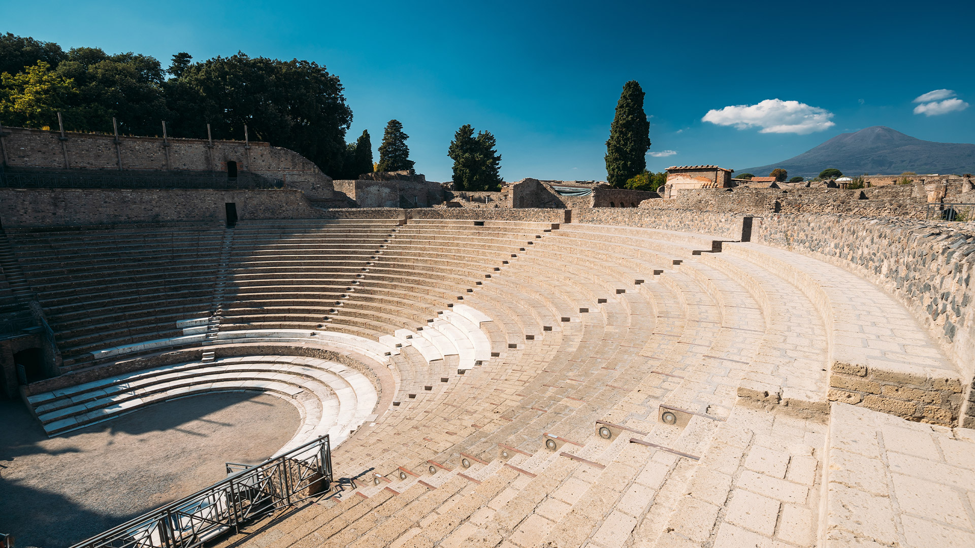 Large Roman theatre of Pompeii with Mount Vesuvius in the background.
