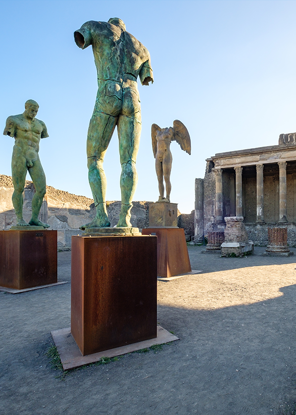 Sculptures in the Pompeii Forum Contemporary bronze sculptures displayed among the ruins of the Pompeii Forum.