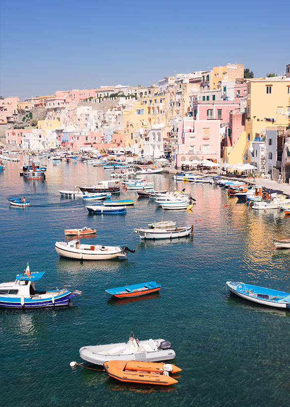 Colorful fishing boats moored in Procida’s harbor.